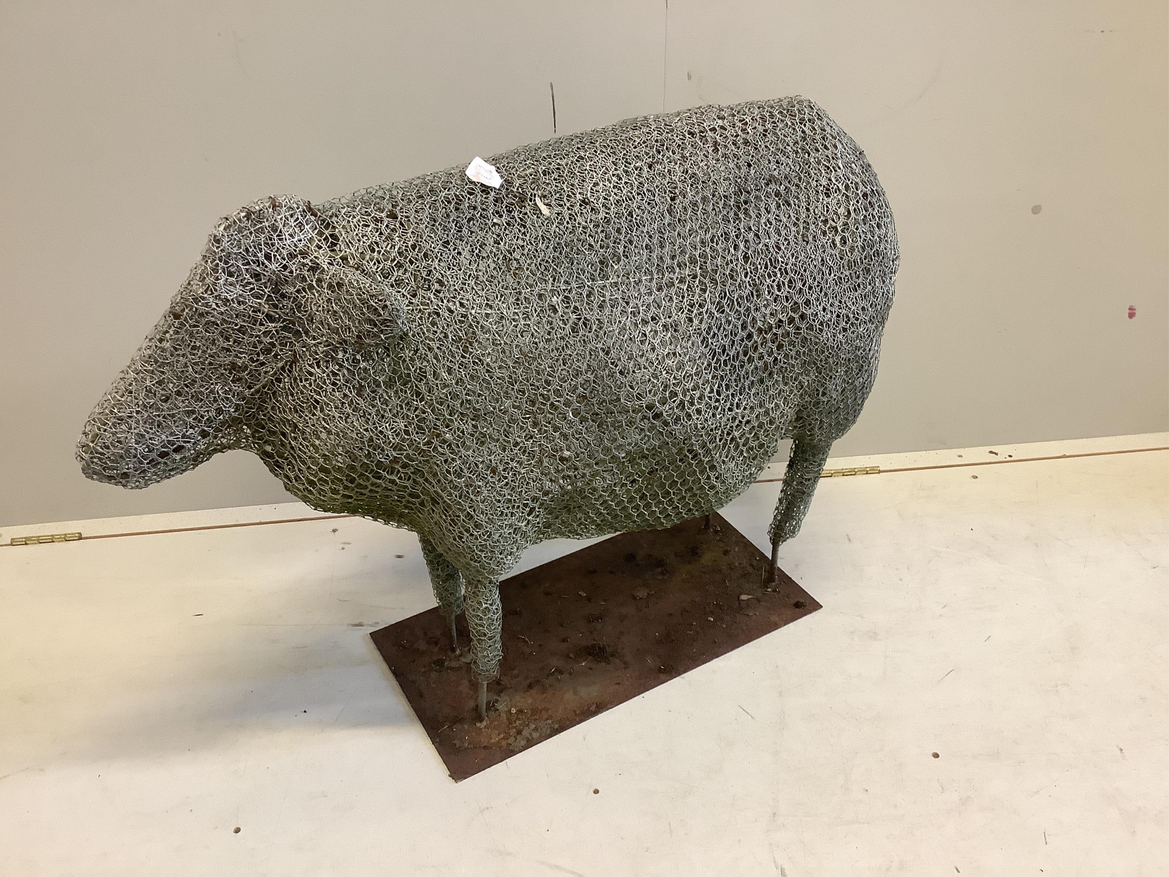 A Rupert Till wire work sculpture of a sheep on rectangular iron stand. Length 100cm, height 75cm. Condition - weathered but fair